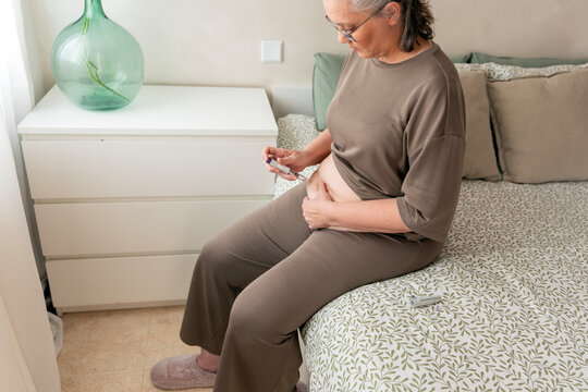 Mature woman self-administering GLP-1 medication