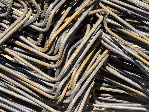 Bent steel rebar pile for reinforced concrete construction