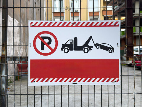 No parking warning sign on a residential fence