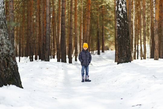 Young boy in snowy park in early spring