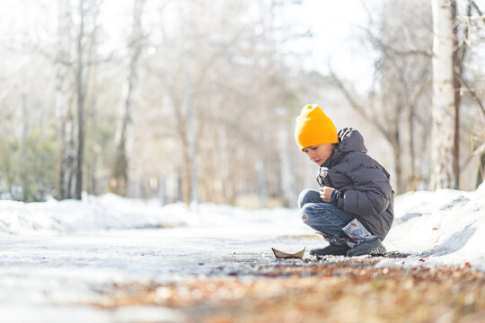 Boy in park during early spring exploring nature