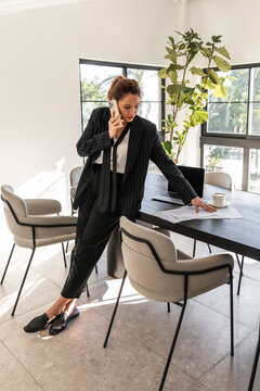 Businesswoman multitasking in modern office setting