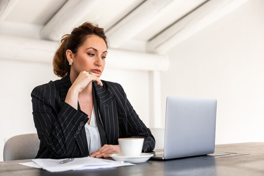 Businesswoman working thoughtfully at office desk