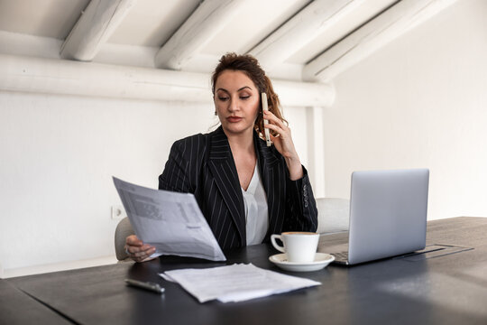 Businesswoman multitasking in a modern office environment