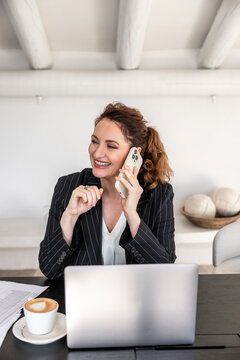 Businesswoman engaging in phone conversation at desk