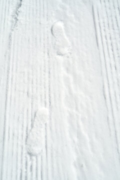 Footprints on snow create a clear path on a winter day