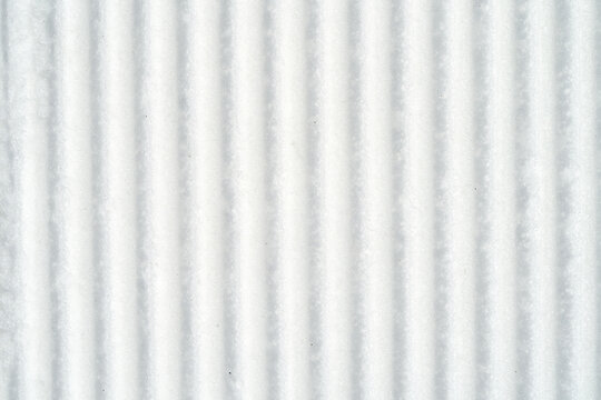 Snow texture pattern showing lines and grooves under soft light