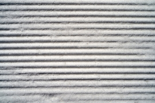 Snow texture on ground showing lined patterns from natural formation