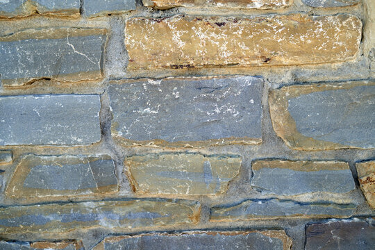 Stone wall texture with varied colors and sizes in natural light