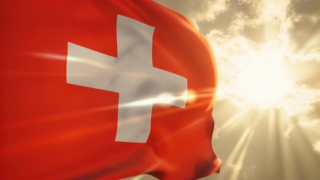 Swiss flag waving in slow motion against bright sun rays