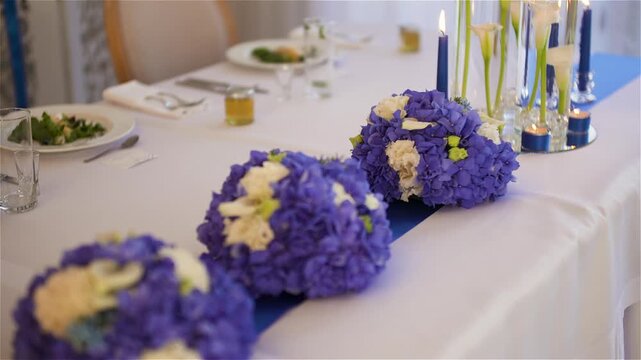 Purple floral centerpieces on a decorated banquet table