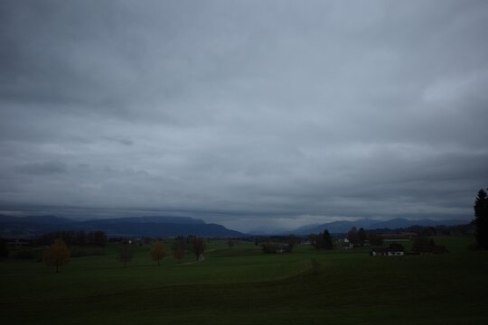 Overcast Sky Over Rural Landscape with Mountains