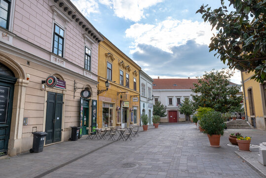 P&eacute;cs, Hungary &ndash; May 1, 2026: Historic pedestrian street lined with shops and traditional architecture in downtown P&eacute;cs