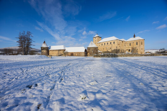 Tocnik Castle in winter with snow covered landscape