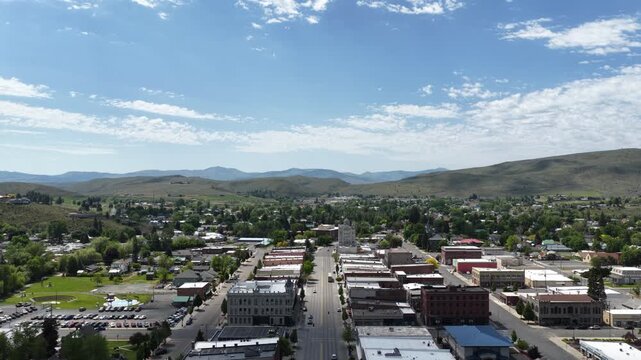 Aerial back away from historic Oregon Trail town Baker City Oregon in spring