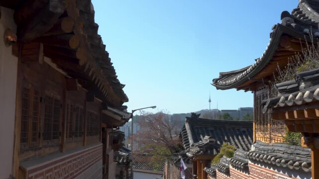 Bukchon Hanok Village with Korean flag and Namsan TV Tower in Seoul, South Korea. Horizontal panning footage