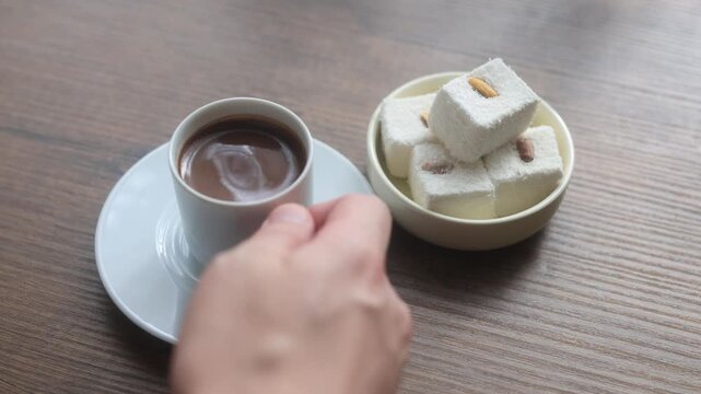 Close-up of traditional Turkish coffee served with delicious Turkish delight lokum on an elegant platter