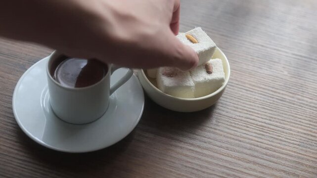 Close-up of traditional Turkish coffee served with delicious Turkish delight lokum on an elegant platter