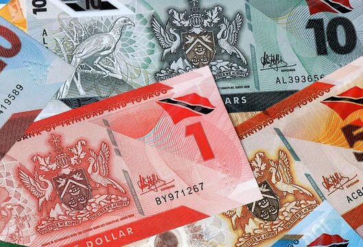 Trinidad and Tobago dollar money banknotes bunch on table. Trinidad and Tobago bills of TTD currency