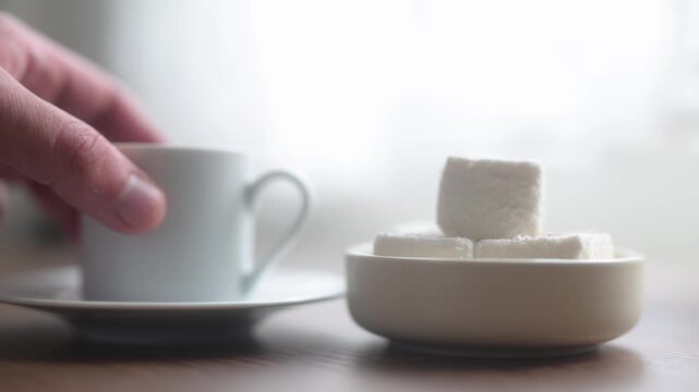 Close-up of traditional Turkish coffee served with delicious Turkish delight lokum on an elegant platter