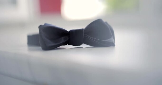 Black bow tie on a bright white surface with soft shallow focus