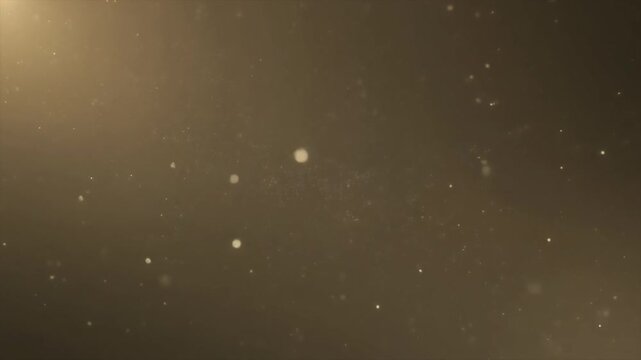 Abstract golden bokeh particles and warm light leaks on dark background
