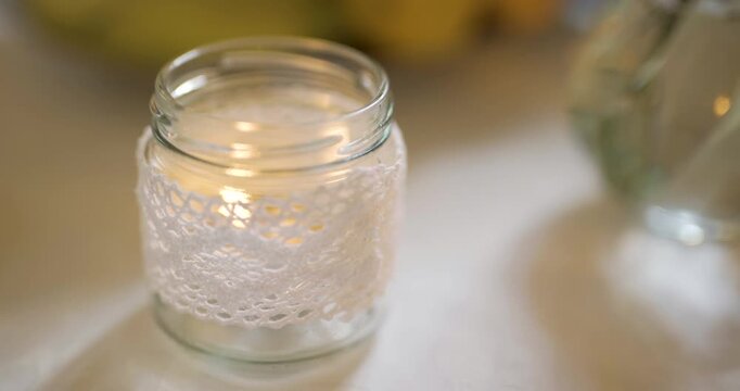 Textured clear glass jar on a softly lit table