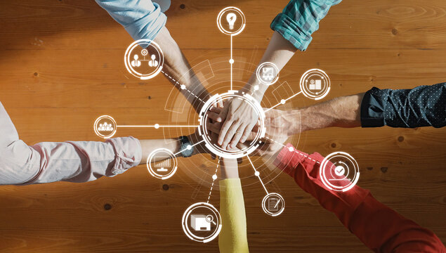 Hands coming together symbolize teamwork and collaboration in a modern workspace, enhanced by digital icons that represent innovation, creativity, and connection among individuals. Amity