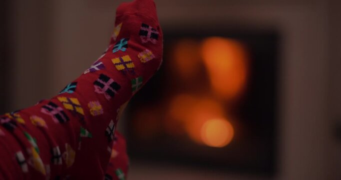 Red patterned gloved thumb in warm firelight