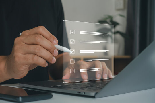 Business performance checklist concept. Businessman using laptop for online checklist survey, filling out digital form checklist. take assessment, questionnaire, evaluation, online survey, online exam