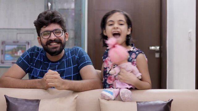 Indian dad and little girl playing in their living room - happy family. Medium shot of a joyful daughter with her father  - father daughter bonding