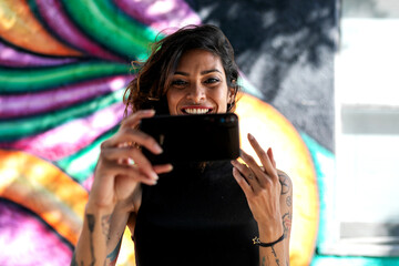 Woman taking selfie vibrant mural © Rawpixel.com