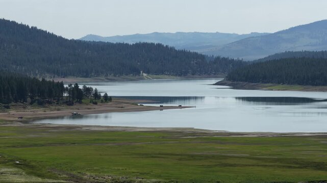 Aerial of Phillips Lake shoreline in Baker City Oregon in spring time in Whitman National forest