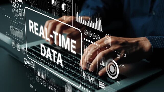 Hands typing on laptop with animated graphics showcasing real-time data analytics and technology interface concepts for business insights. Asymptotic smart data analytic.