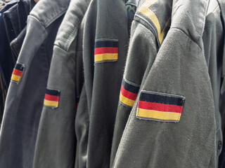 Obraz premium Vintage German Military Uniforms Displayed for Sale