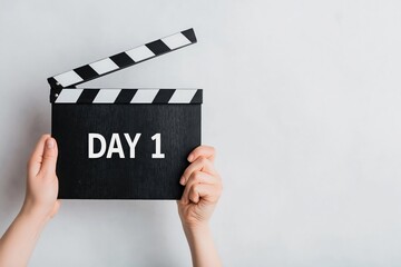 Obraz premium Clapperboard for filmmaking production start day 1 hands holding movie cinema video beginning