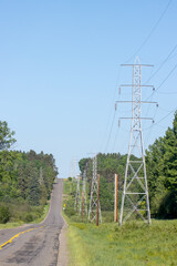 Obraz premium high voltage power lines in the countryside on a sunny spring day