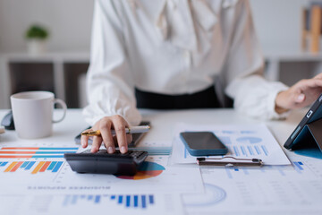 Fototapeta premium Analyze report Financial Businesswomen the graph of the company's performance to create profits and report growth, Market research reports and income statistics, Financial and Accounting concept.