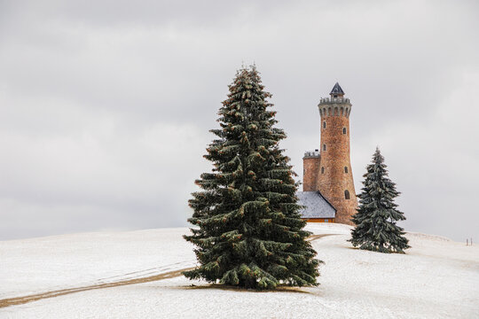 Observation tower standing on snowy hill in winter