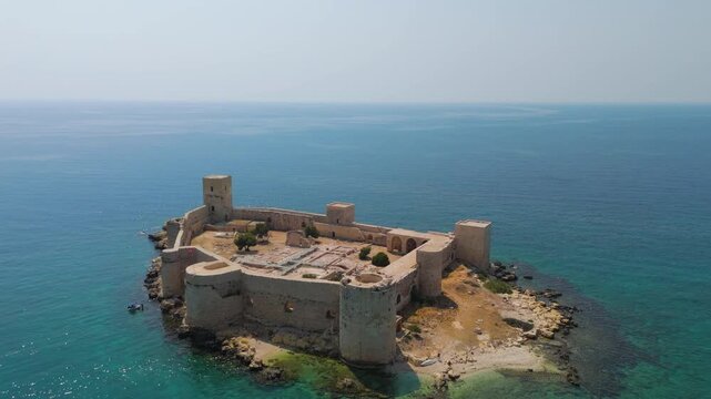 Kizkalesi, Mersin, Turkey. Aerial view of Maiden Castle, a medieval stone fortress on an islet in the Mediterranean Sea, surrounded by turquoise water under clear summer sky.. Aerial View, Point of i