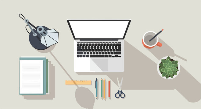 A cluttered desk with office supplies and laptop