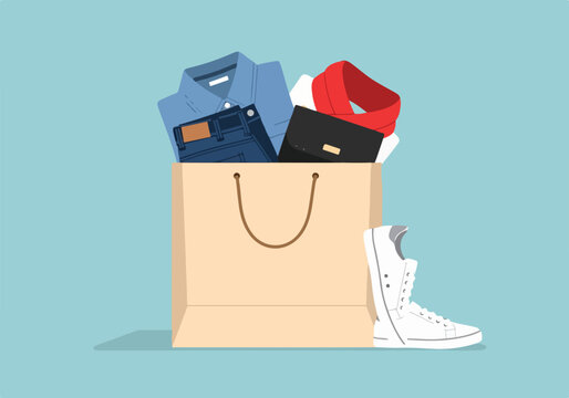 A beige shopping bag overfilled with clothes and accessories