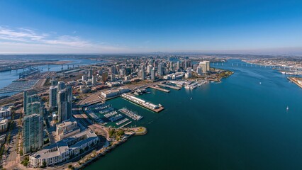 Obraz premium Aerial view of modern city skyline and river marina at dusk