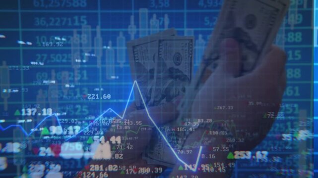 Double exposure showing hands counting a thick stack of one hundred dollar bills overlaid with glowing blue and green stock market charts, symbolizing trading profits.