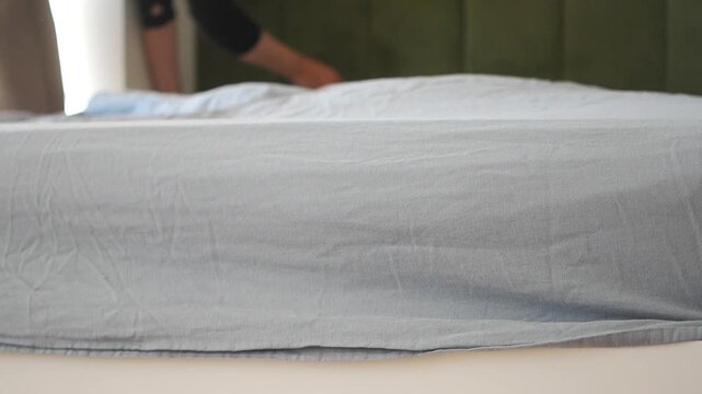 Making a bed with fresh sheets in a bedroom today
