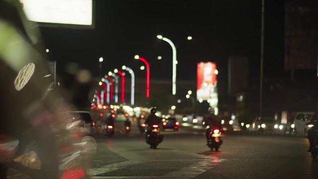 Makassar City Night Traffic with Bright Vehicle Lights and Urban Atmosphere