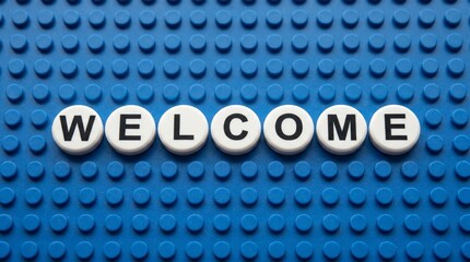 Naklejka premium Creative LEGO‑style welcome sign with white circular tiles on a blue baseplate, bold black letters spelling WELCOME — playful greeting design for hospitality, fun, and introduction visuals