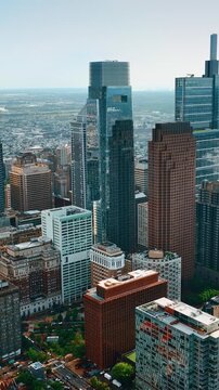 Philadelphia skyline aerial view featuring Comcast technology center and downtown skyscrapers during sunny day.