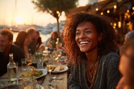 joyful woman laughing at outdoor dinner party