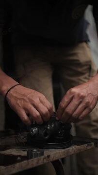 close up of a hand holding a car engine